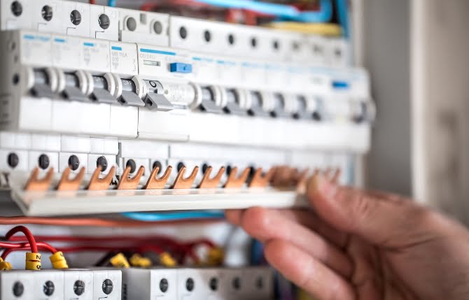 man-electrical-technician-working-switchboard-with-fuses-installation-connection-electrical-equipment-close-up Circuit Breakers (Bulk & Custom) - Image 1